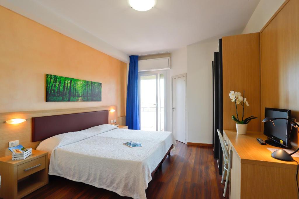 Postel nebo postele na pokoji v ubytování Hotel Grifone