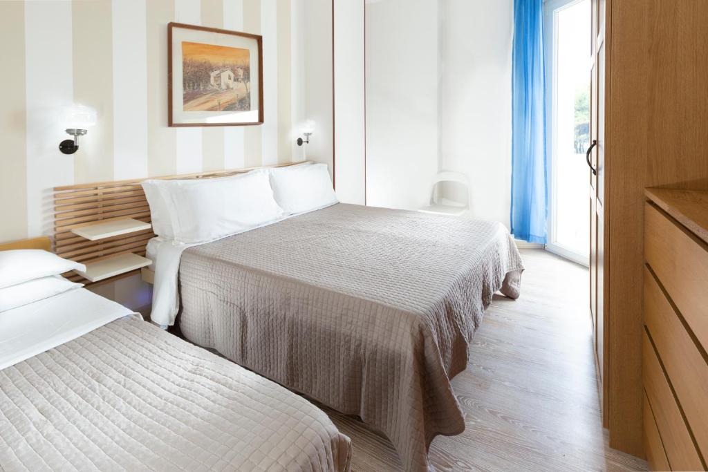 Postel nebo postele na pokoji v ubytování SoleMare Hotel e Residence