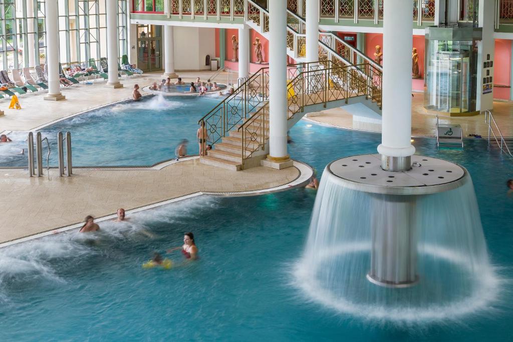 a group of people in a swimming pool in a building at Spa Resort PAWLIK-AQUAFORUM in Františkovy Lázně
