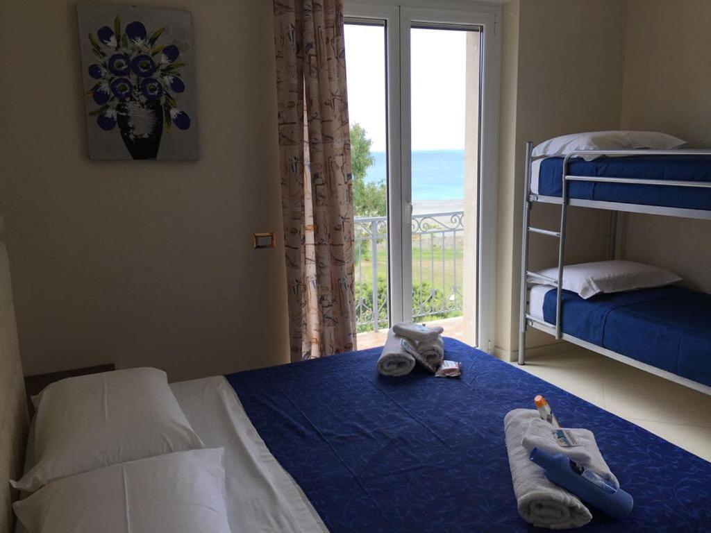 een slaapkamer met een bed met handdoeken en een raam bij B&B Riviera Azzurra in Cirella