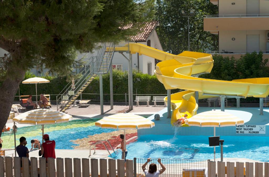 a water park with a slide in a swimming pool at SoleMare Hotel e Residence in Misano Adriatico
