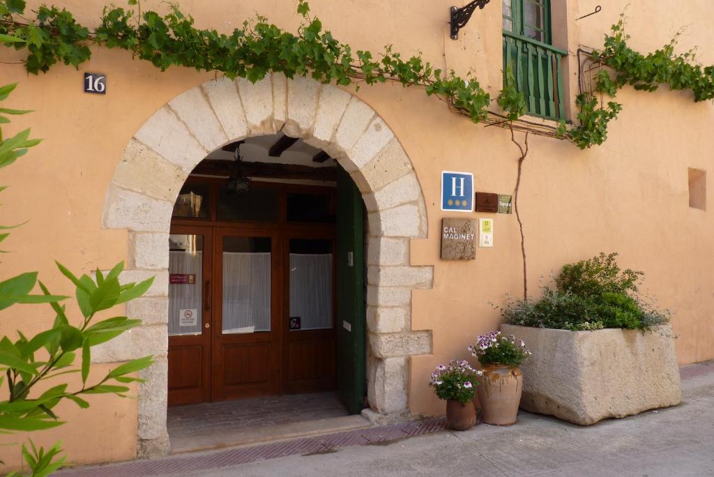 an entrance to a building with a wooden door at Cal Maginet in Vilavert