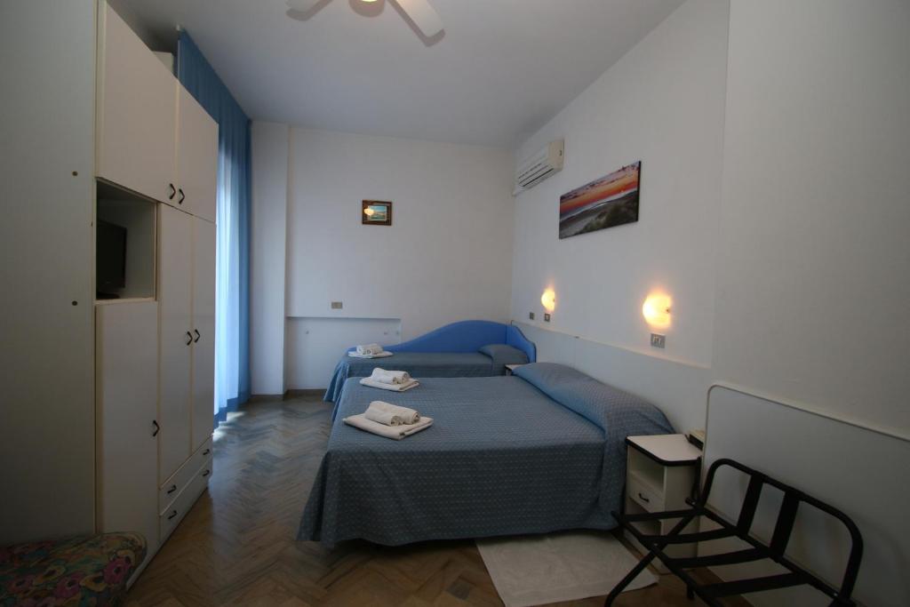 Postel nebo postele na pokoji v ubytování Hotel Tre Assi