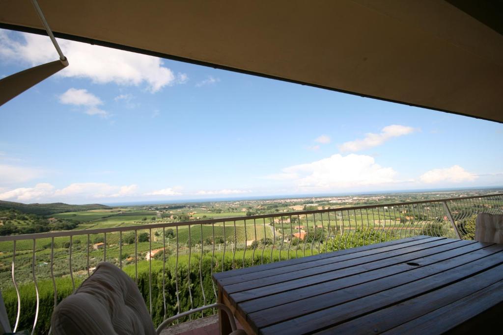 a view from the balcony of a house with a table at Terrazza Vista Mare in Castagneto Carducci