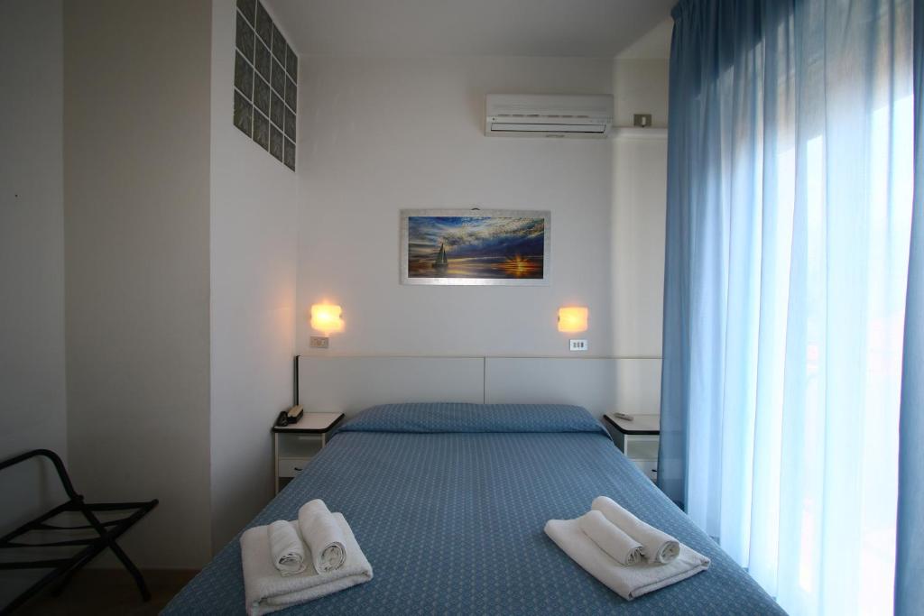 Postel nebo postele na pokoji v ubytování Hotel Tre Assi