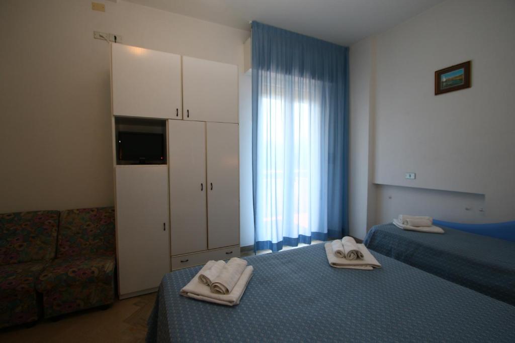 Postel nebo postele na pokoji v ubytování Hotel Tre Assi