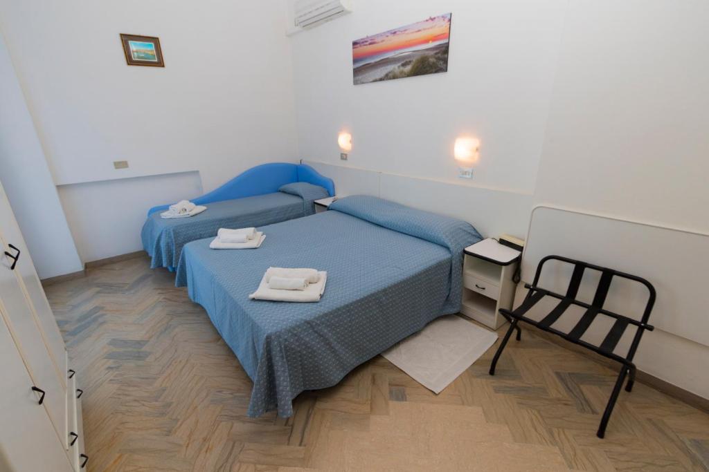 Postel nebo postele na pokoji v ubytování Hotel Tre Assi