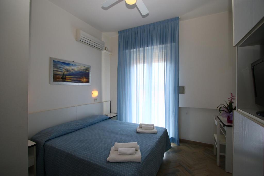 Postel nebo postele na pokoji v ubytování Hotel Tre Assi
