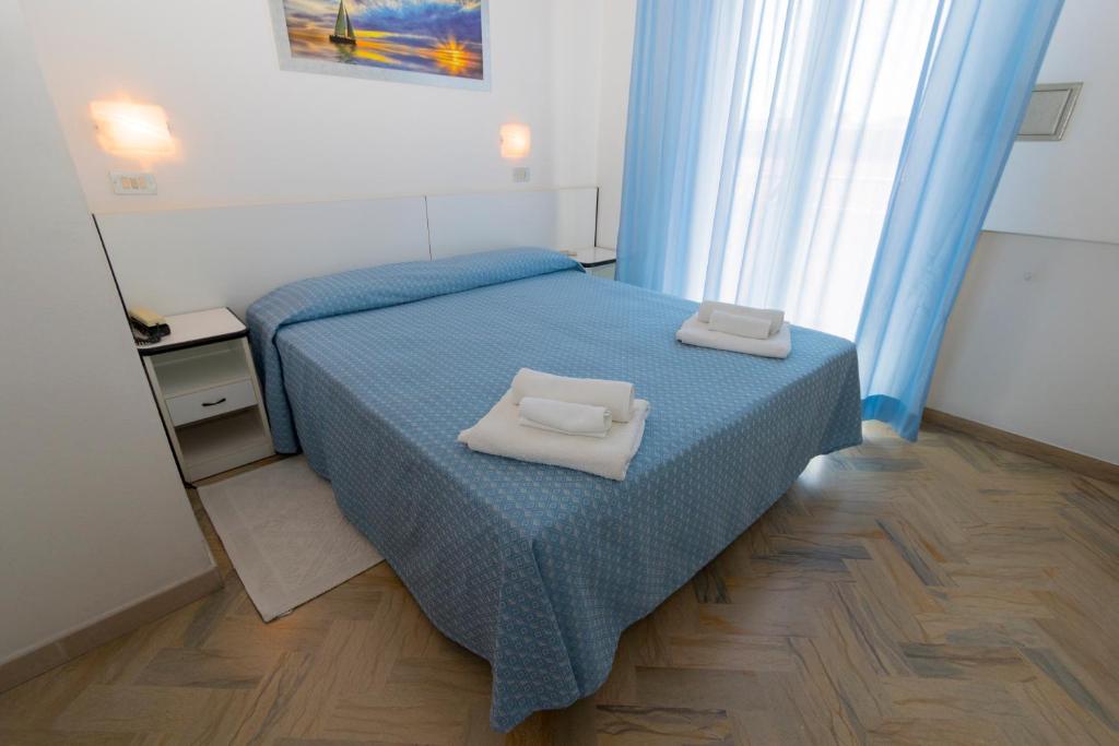 Postel nebo postele na pokoji v ubytování Hotel Tre Assi