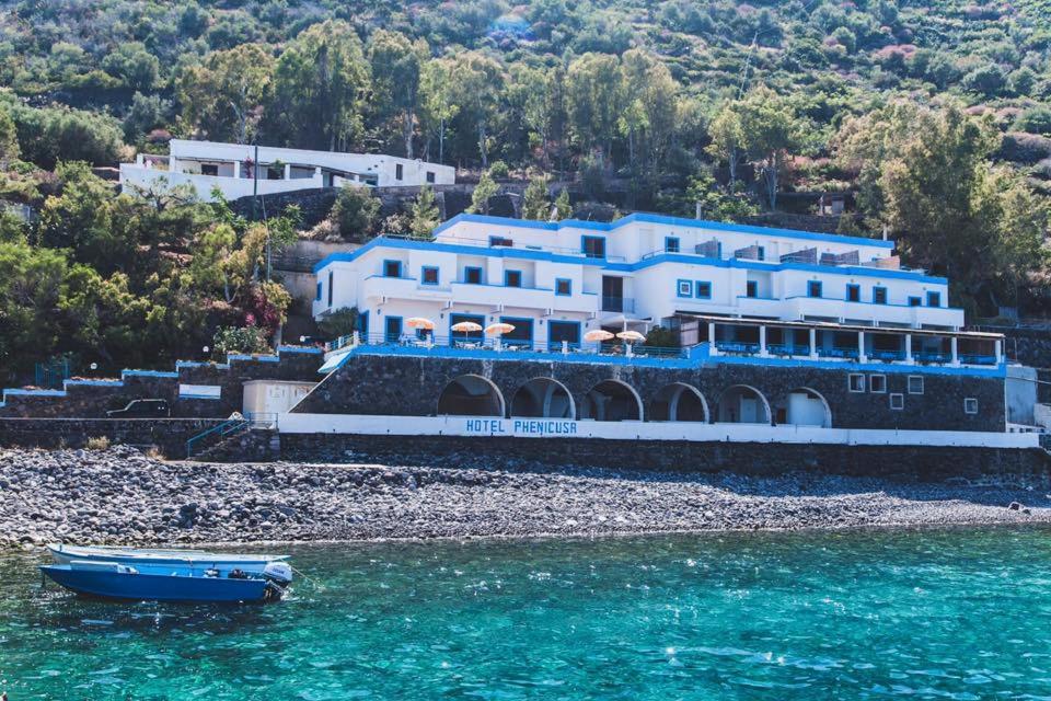 a house on the shore of a body of water at Hotel Phenicusa in Filicudi