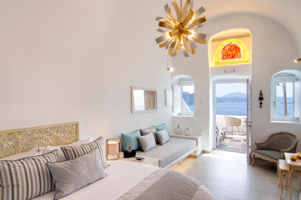 a living room with a bed and a couch at Secret Legend Suites in Oia