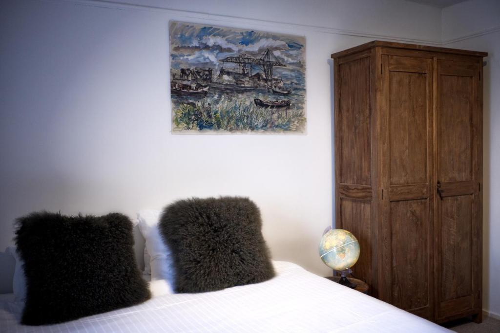 a bedroom with a bed and a painting on the wall at Cozy Pijp Apartment Amsterdam in Amsterdam