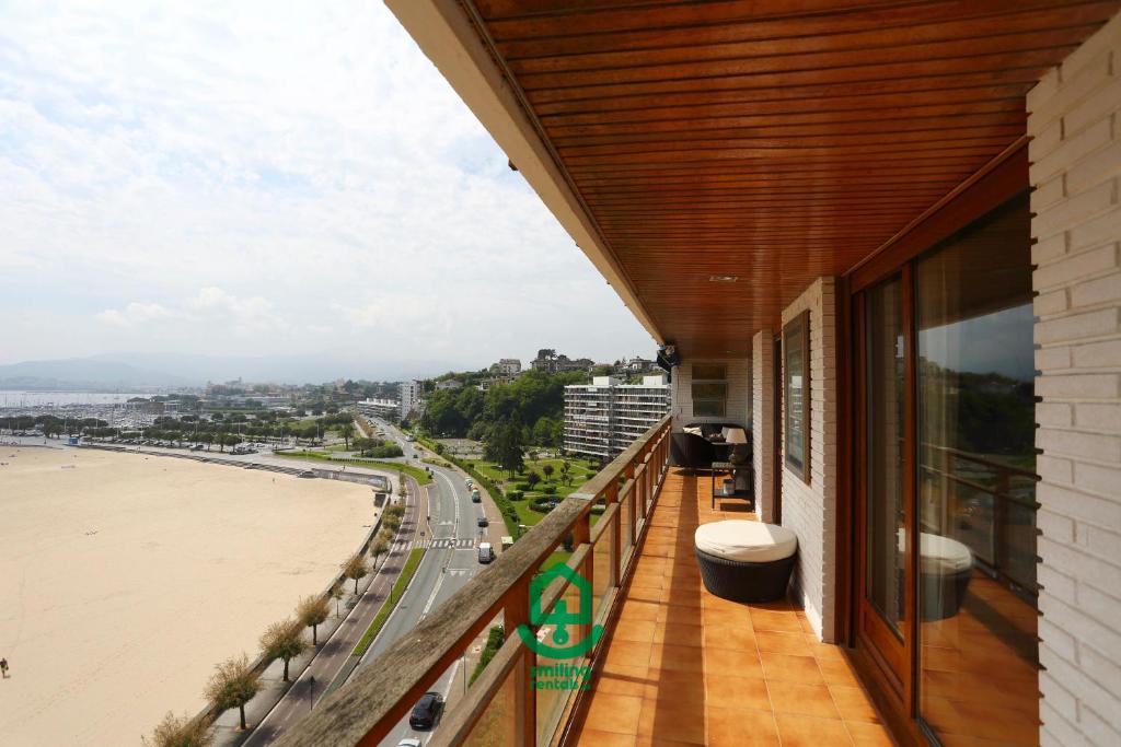 a balcony with a view of the beach at Marla by Smiling Rentals in Hondarribia