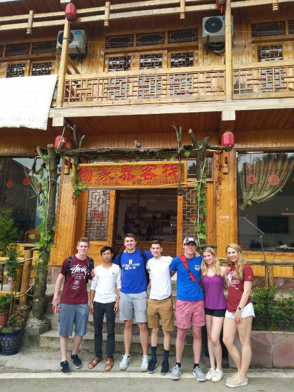 a group of people standing in front of a building at Yangjiajie Inn in Zhangjiajie