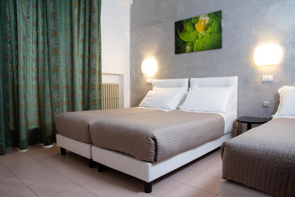 Posteľ alebo postele v izbe v ubytovaní Hotel Columbia