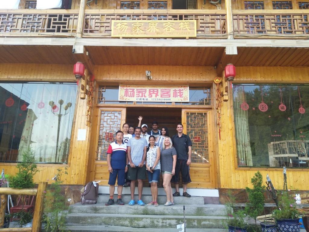 a group of people standing in front of a building at Yangjiajie Inn in Zhangjiajie