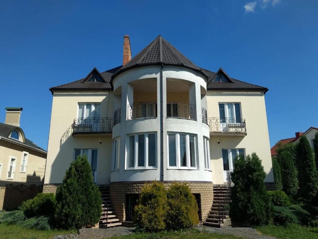 a large white house with a turret at Хостел Lutsk G84 in Lutsk