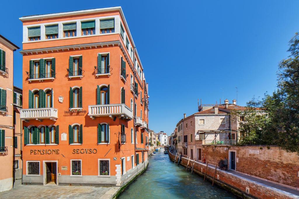 a view of a canal in a city with buildings at Pensione Seguso in Venice