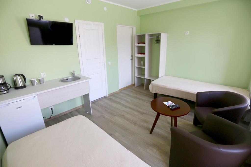 a small room with a bed and a desk at Hostel Sport in Haapsalu