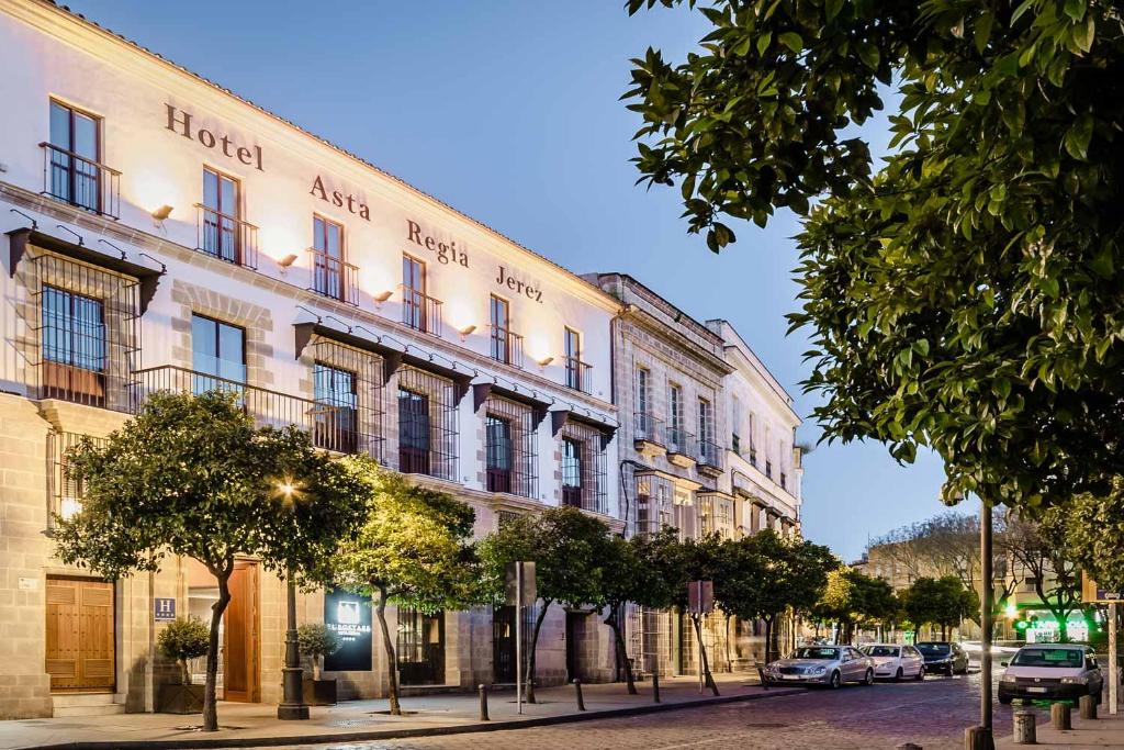 a building on a street with cars parked in front of it at Eurostars Asta Regia Jerez in Jerez de la Frontera