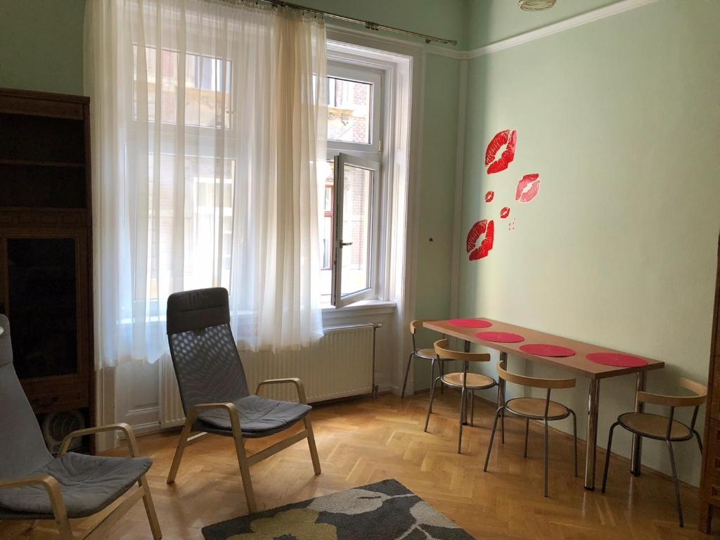 a room with a table and chairs and a window at Summer place in Budapest