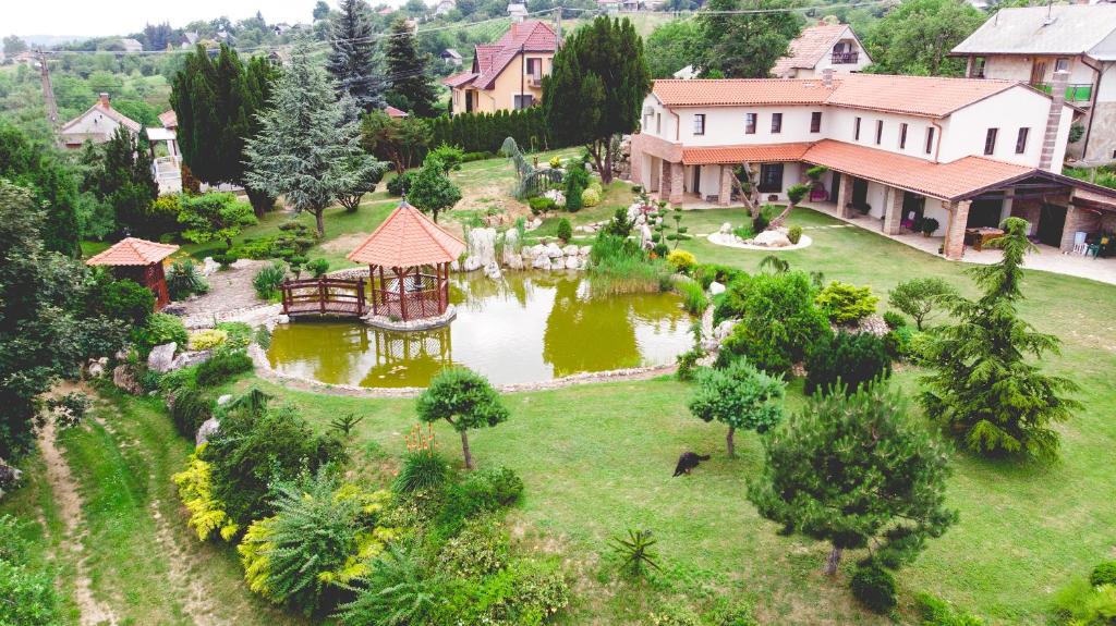 an aerial view of a house with a pond at Villa Garden in Zalaegerszeg