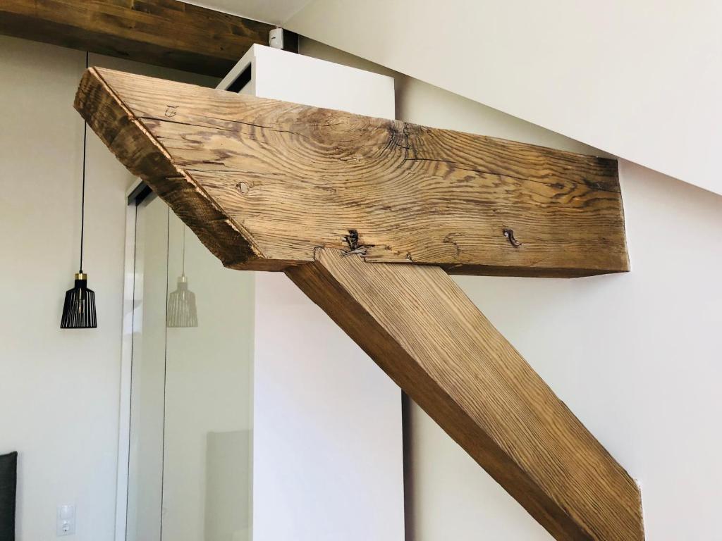 a wooden cross hanging on a wall at Memel home old city apartment in Klaipėda