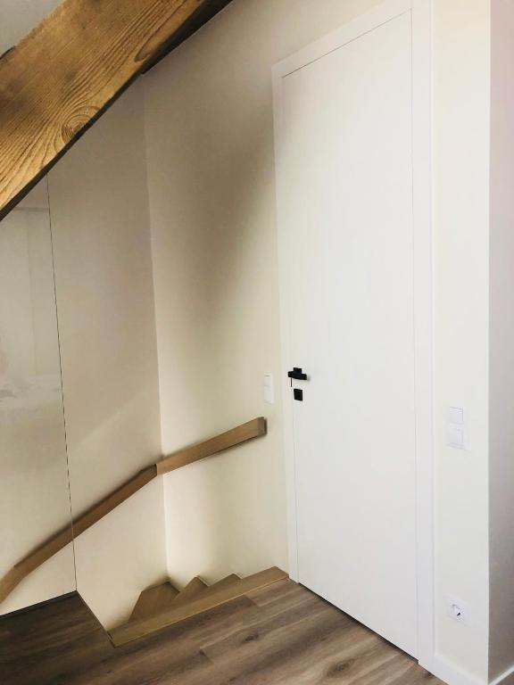 a room with a staircase and a sliding door at Memel home old city apartment in Klaipėda