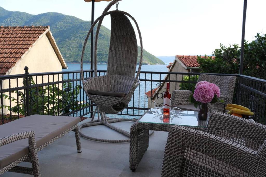 a patio with a table and chairs on a balcony at Mara Apartments in Perast