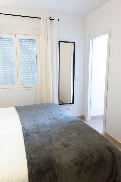 sypialnia z dużym łóżkiem i 2 oknami w obiekcie La Tierra Sur apartment Malaga Center w Maladze
