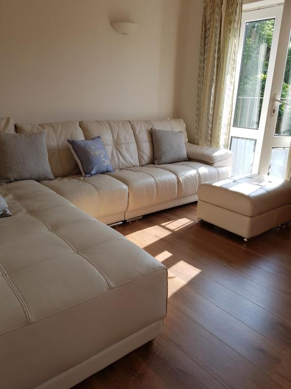 a living room with a white couch and a window at Coast house, Norfolk road,Littlehampton, Free parking driveway in Littlehampton