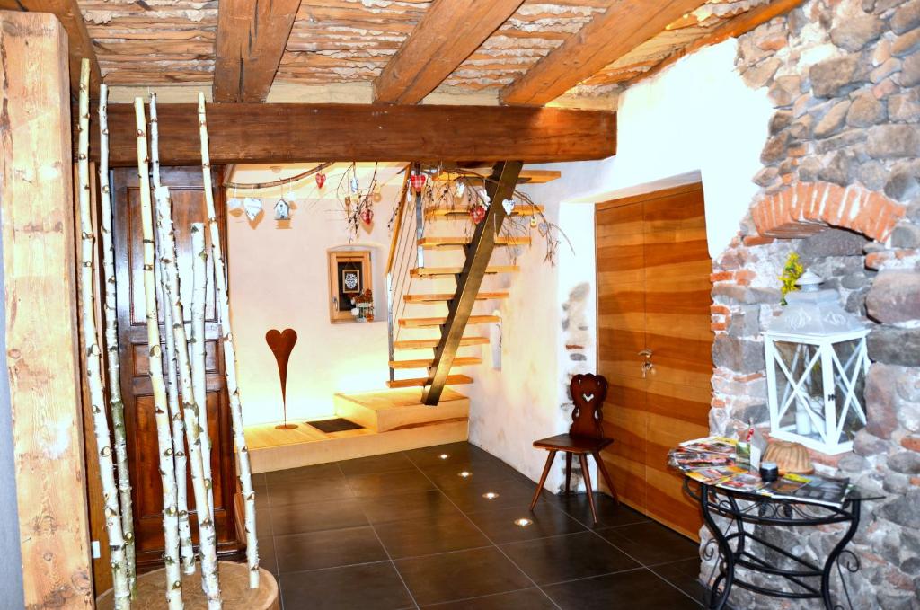 a room with a staircase and a stone wall at La Parenthèse in Kaysersberg