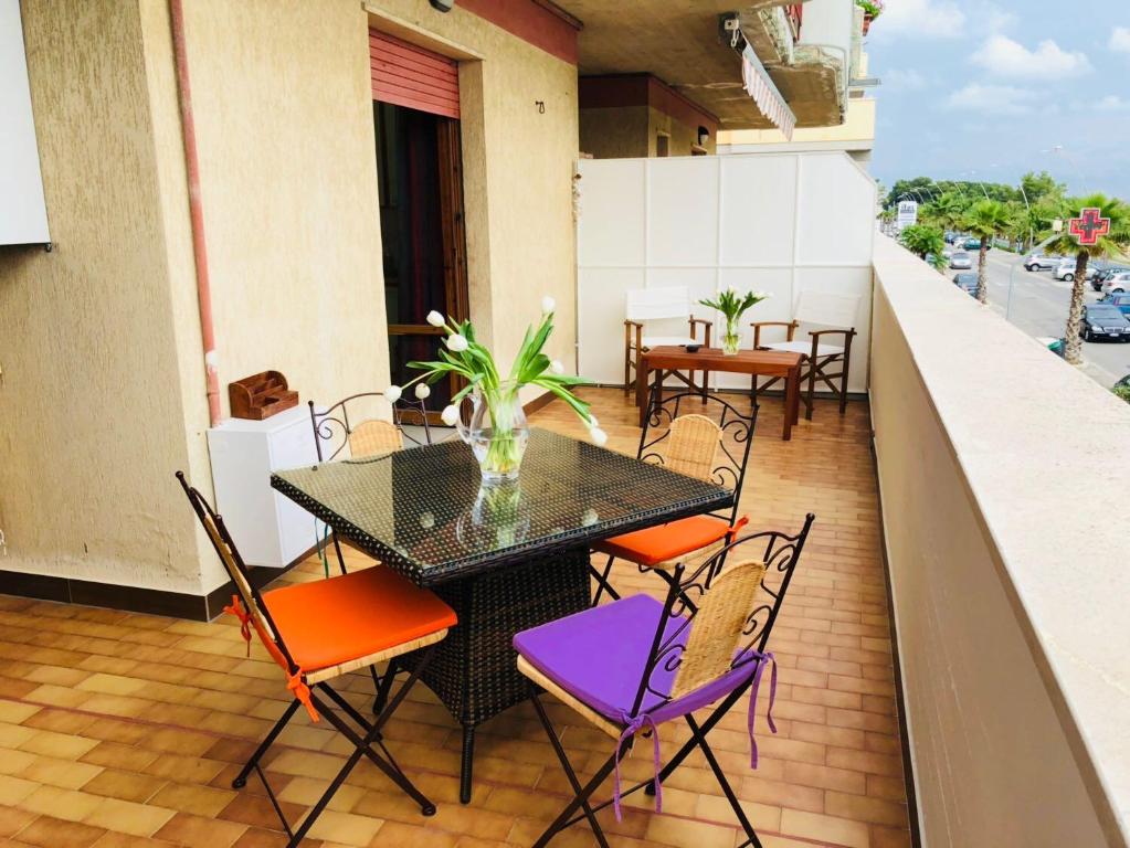 un patio con tavolo e sedie sul balcone. di casa fronte mare ad Alba Adriatica