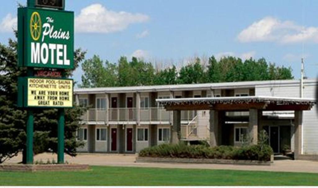 un motel con un cartel frente a un edificio en Plains Motel, en Brooks