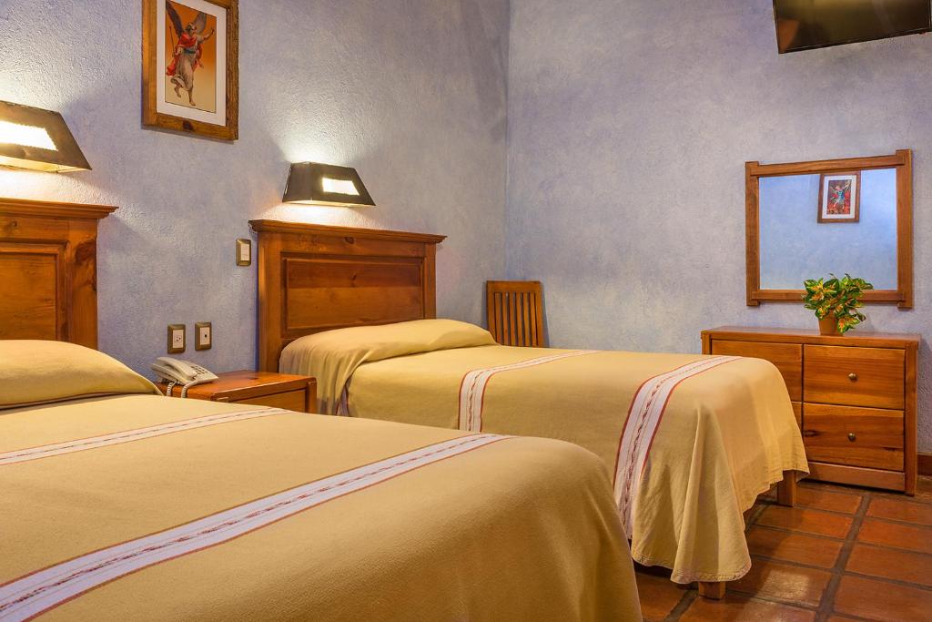Postel nebo postele na pokoji v ubytování Hotel Refugio del Angel
