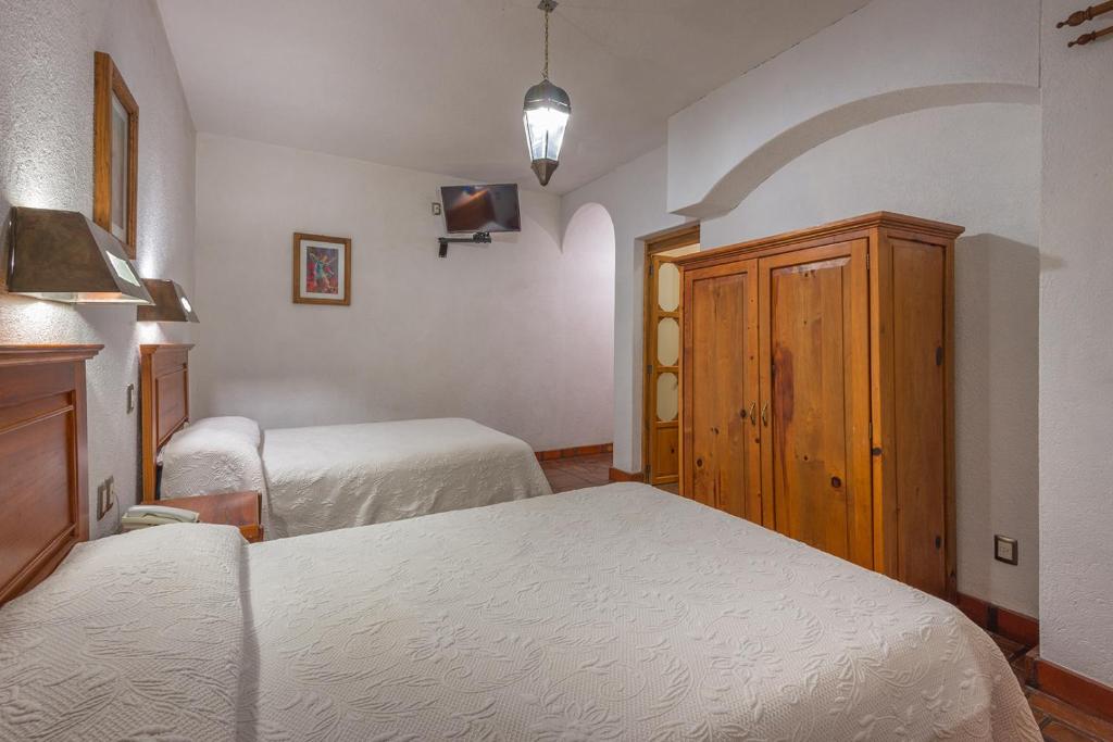Postel nebo postele na pokoji v ubytování Hotel Refugio del Angel