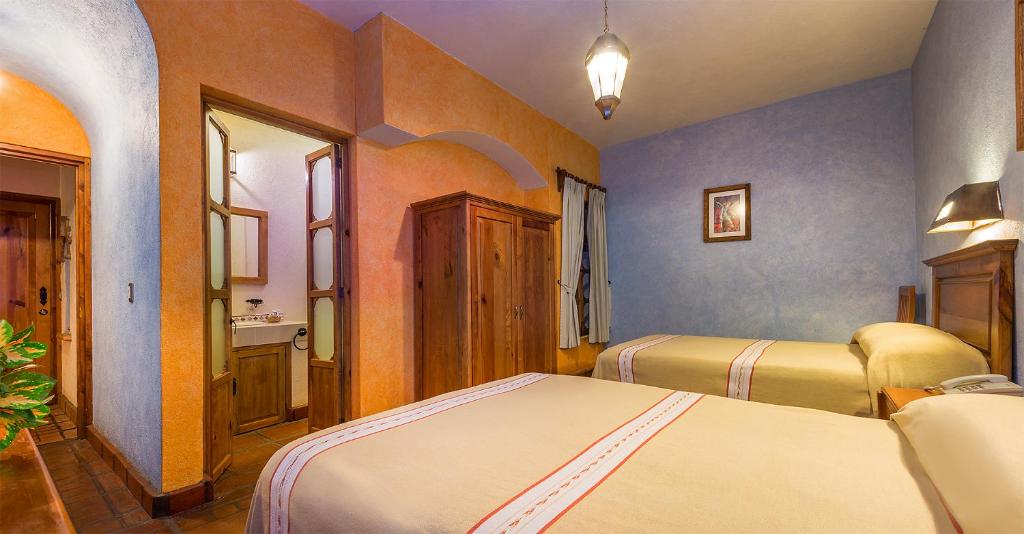 Postel nebo postele na pokoji v ubytování Hotel Refugio del Angel