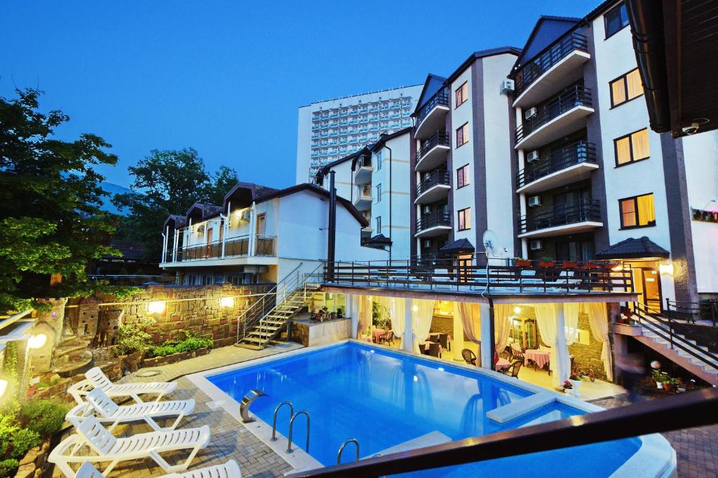 a swimming pool in front of a building at Orlitsa Hotel in Gelendzhik