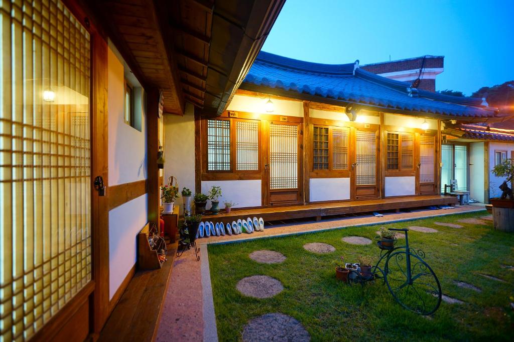 a house with a bike parked in the yard at Hanok Dream in Jeonju