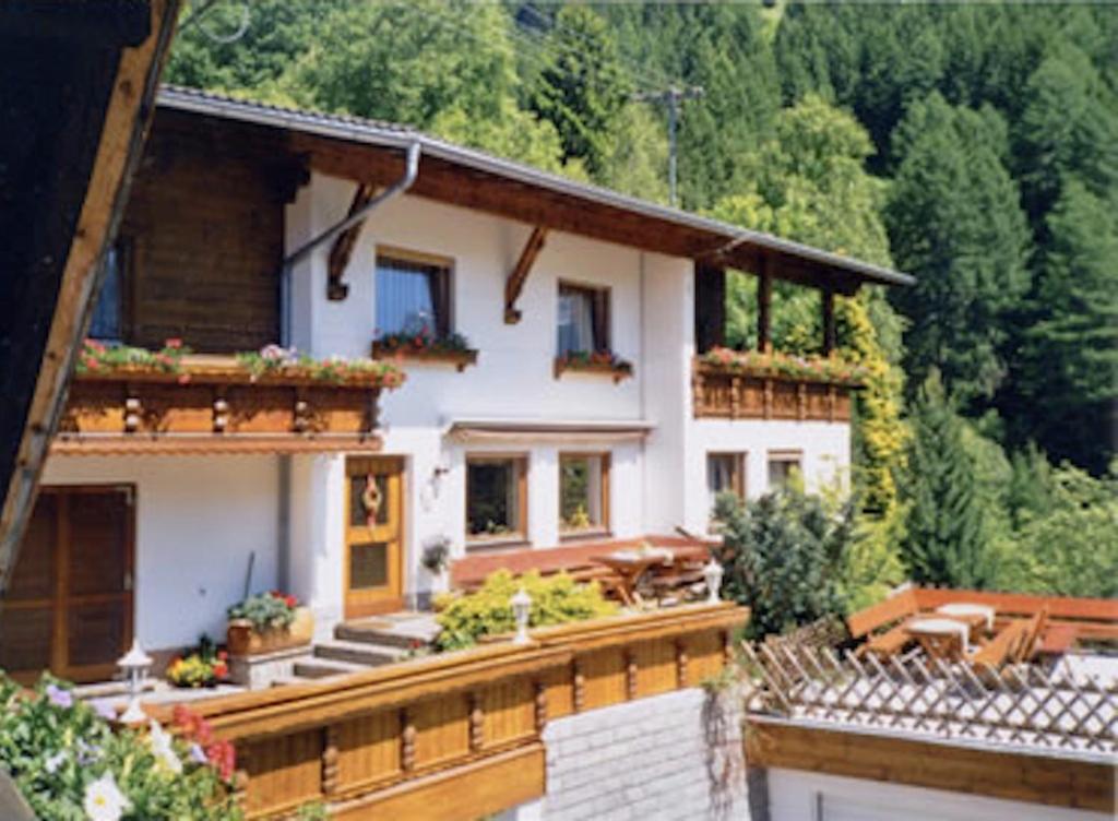 a large white house with stairs and plants on it at Haus Kirschner in Jerzens