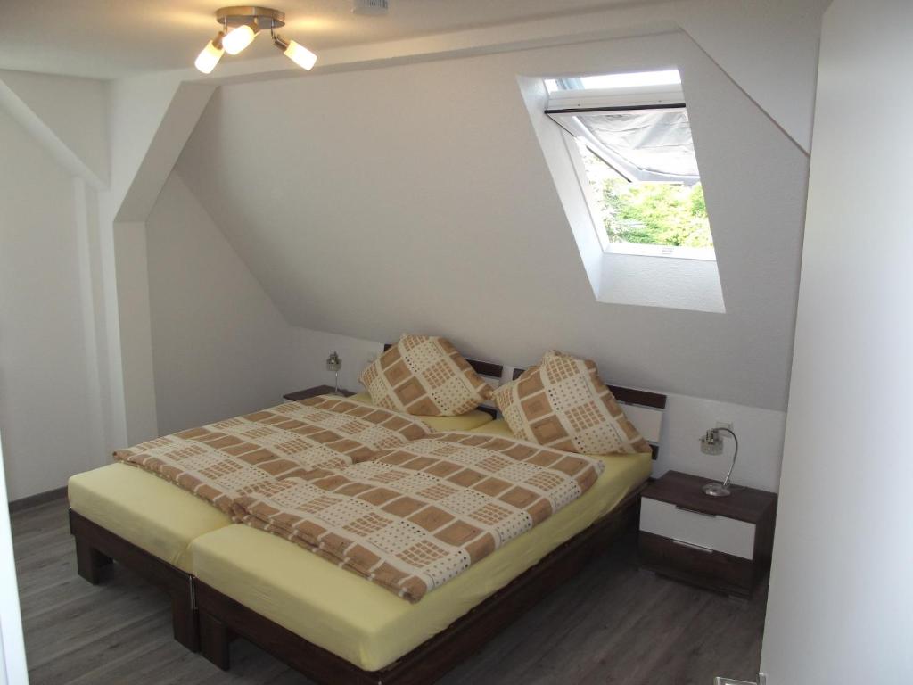 a bedroom with a bed and a window at Ferienwohnung Schnell Bad Saulgau in Bad Saulgau