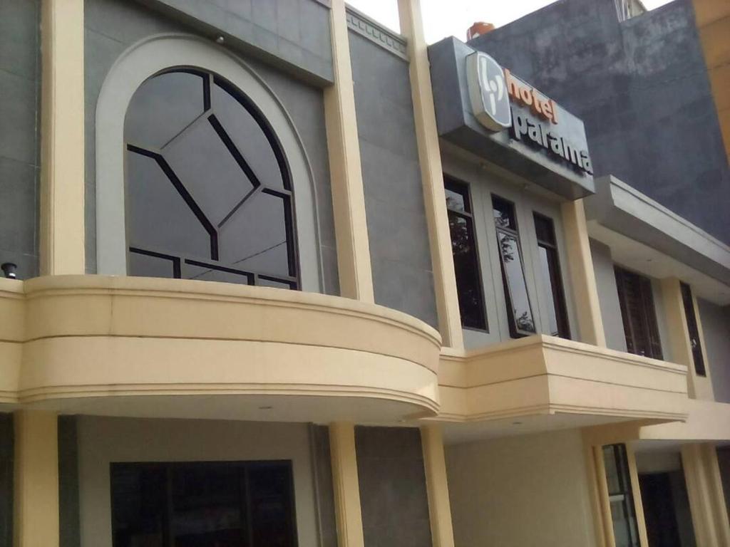 a building with a sign on the front of it at Parama Hotel in Wonosobo