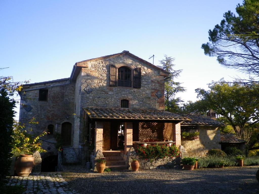 an old stone house with a window on top of it at Torre Di Sant'Ansano in Corsano