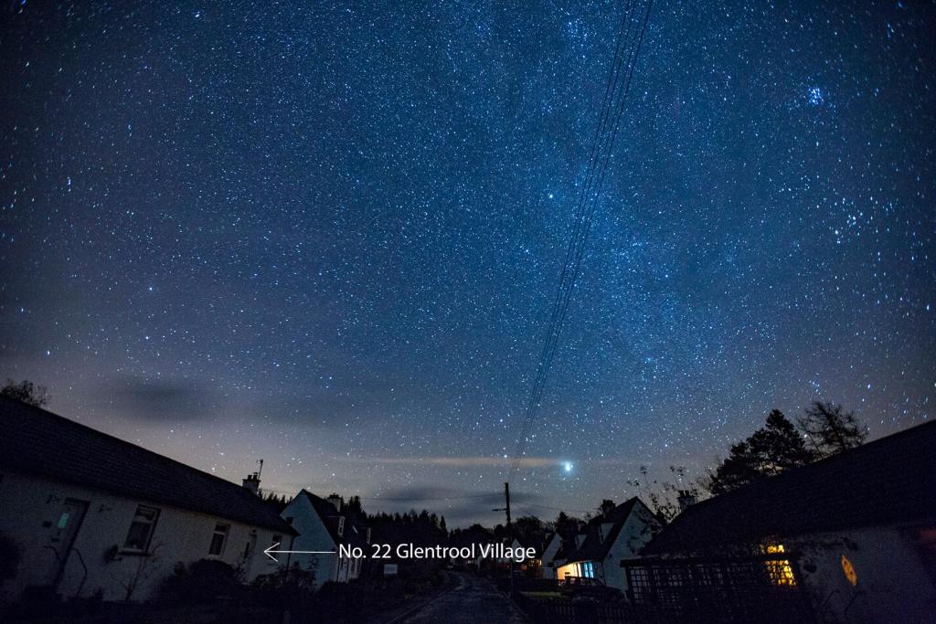 a starry night with a kite flying in the sky at Kelpies Cottage in Newton Stewart