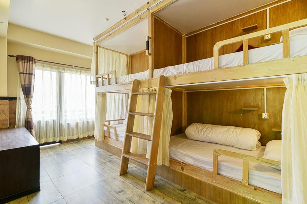 a bedroom with two bunk beds in a room at Hotel Forest Lake Backpackers' Hostel in Pokhara