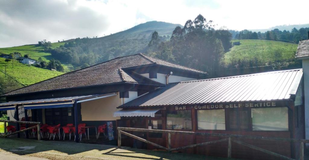 a building with a sign that readseat mountain self service at Albergue De Oneta in Oneta