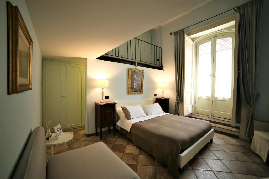 A bed or beds in a room at B&B Palazzo Solimena