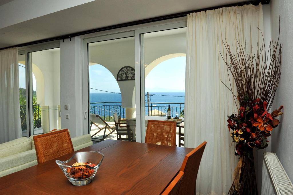 a dining room table with a view of the ocean at Nina Areti in Skiathos