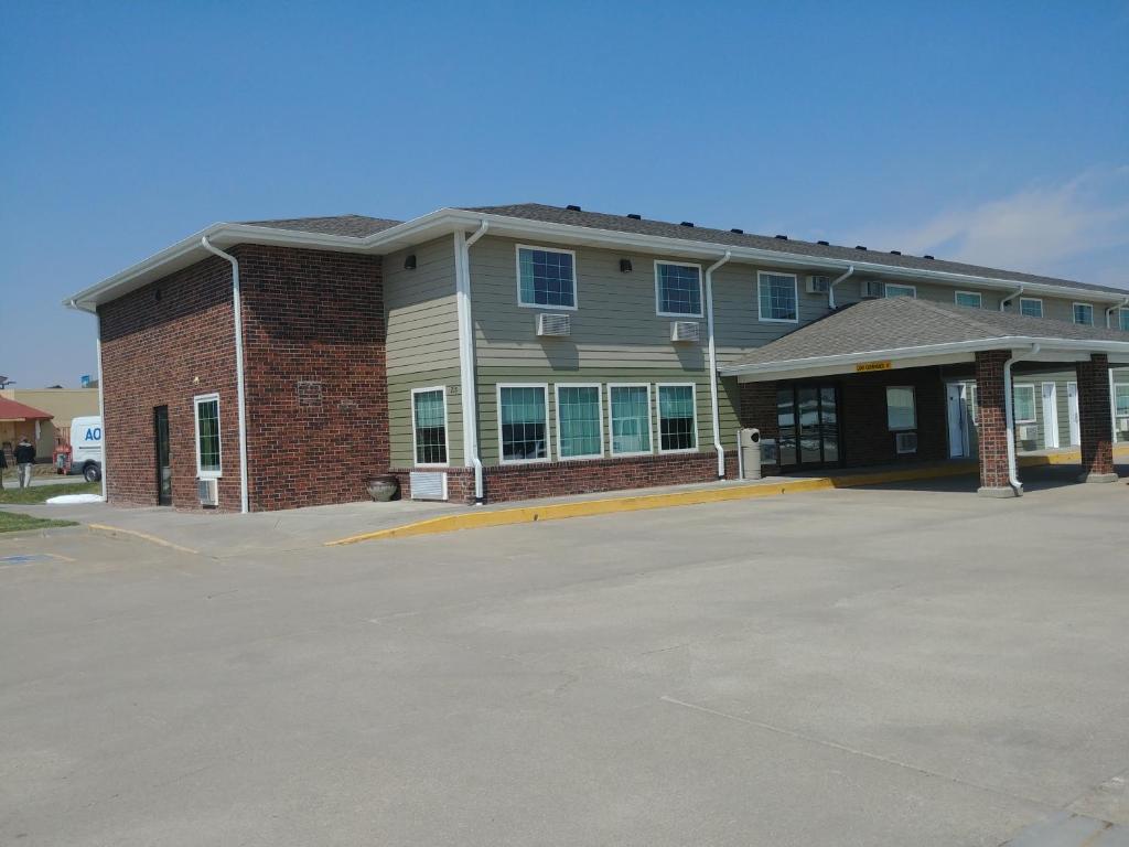 ein Gebäude mit einem Parkplatz davor in der Unterkunft Boarders Inn & Suites by Cobblestone Hotels - Broken Bow in Broken Bow