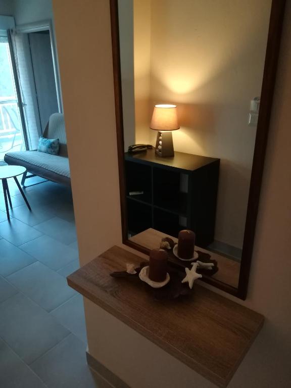 a mirror on a table in a room at Seaview Aparthotel in Nea Potidaea